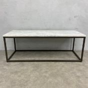 A contemporary coffee table with white marble and composite top raised on a square metal frame. H.44