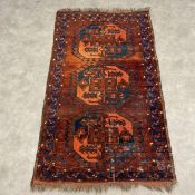 An Afghan Sulayman Ersari Turkmen rug with one row of three guls over an iron red abrash ground