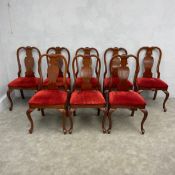 A set of eight early Georgian style teak dining chairs with shaped splats on shell carved cabriole