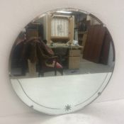 A vintage circular wall mirror with bevelled and engraved plate. Diam.51cm.