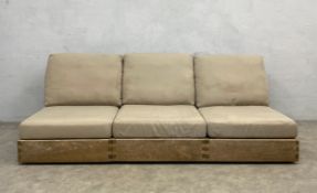 A vintage weathered teak three seater patio sofa having a square slatted back and seat with fitted