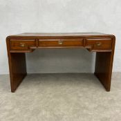 A 20th century Chinese waterfall desk with 'opium mat' bamboo top over three frieze drawers with