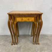 A nest of three graduating Continental kingwood occasional tables with marquetry inlay on cabriole