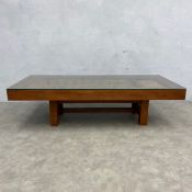 A vintage coffee table made from a heavy 19th century metal bound Indian window shutter set into a