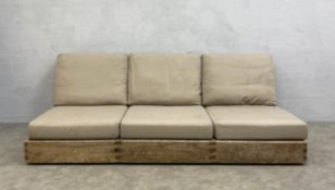 A vintage weathered teak three seater patio sofa having a square slatted back and seat with fitted