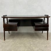 A mid-century Italian oak executive desk with black glass top over four pedestal drawers raised on