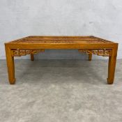 A Chinese hardwood low table with central drop in lattice panels raised on square supports. H.46 W.