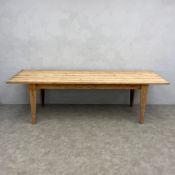 A large 20th century pine farmhouse refectory style dining table with rectangular plank top raised