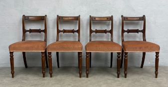 A set of four Regency mahogany dining chairs with acanthus carved backs on turned tapering supports.