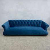 A contemporary four seater Chesterfield style Loaf 'Dixie' sofa with scrolled deep button back and