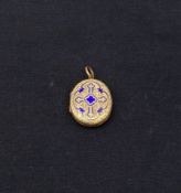 An antique engraved yellow metal and royal blue enamelled quatrefoil locket pendant. Weight: 8.43g