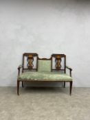 An Edwardian mahogany and satinwood strung two seater sofa with marquetry inlay on square section