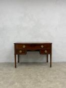 A 19th century mahogany bowfronted side cabinet or small sideboard on square tapering legs on
