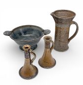 A mixed lot of mid-century salt glazed studio pottery to include a pair of candlesticks, large