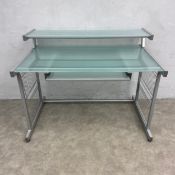 A vintage desk with frosted plate glass superstructural shelf and top over the brushing and wirework