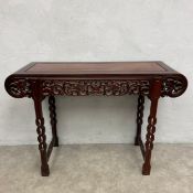 A 20th century Chinese hardwood altar or console table with scrolled panel top over the openwork