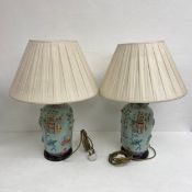 A pair of contemporary Chinese Famille Vert style hand painted porcelain table lamps with shades.