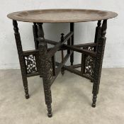 A late 19th/early 20th century Anglo-Indian Benares occasional table with engraved brass tray top