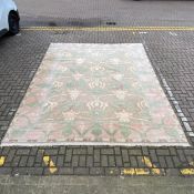 A large Oushak carpet with stylised flowerhead field in pastel colours over a coffee ground within a