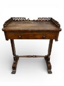 A 19th century rosewood writing or lamp table with openwork gallery surround over the fitted