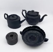 A mixed lot of black basalt stoneware ceramics to include a C.1790 Coalport teapot with figural