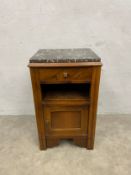 A French walnut Art Deco bedside cabinet with marble top above frieze drawer and panel door