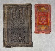 A 19th century Baluch prayer rug with central patterned mihrab field in midnight blue over an oat