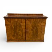 A 20th century flame mahogany hanging cabinet with crossbanded and satinwood inlaid top over a