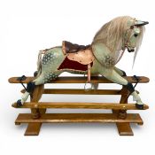 A vintage hand painted and carved dapple grey rocking horse with leather saddle and real hair by