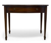 A 20th century bow-fronted mahogany sideboard or console table with single frieze drawer raised on