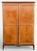 A 19th century French Louis XVI style walnut and kingwood armoire with crossbanded cornice over