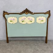 A French 19th century Louis XV style giltwood footboard with central painted figural fabric