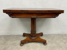 A William IV rosewood card table with foldover swivel action top on acanthus carved pedestal