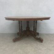 A Victorian walnut dining table with marquetry inlaid and quarter-veneered top over the turned and