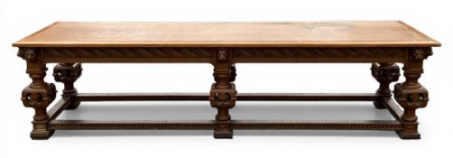 A late 19th century Gothic Revival oak refectory table with canted plank top over the carved