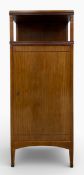 An Art Nouveau style mahogany music cabinet with open superstructure over the single door