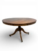 An early 19th century rosewood dining table with tilt top action on swept supports. H.72 Dia. 122cm.