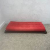 A contemporary 'Futura' daybed or chaise longue with red canvas upholstered adjustable mattress
