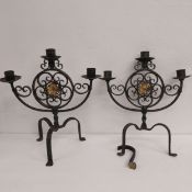 A pair of painted wrought iron candelabras with three branches and central gilt flowerhead raised on