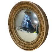 A vintage convex Regency style wall mirror in a moulded and painted plaster frame. Diam.34cm.