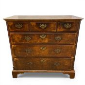 An 18th century Georgian walnut chest of three short over three long crossbanded drawers flanked
