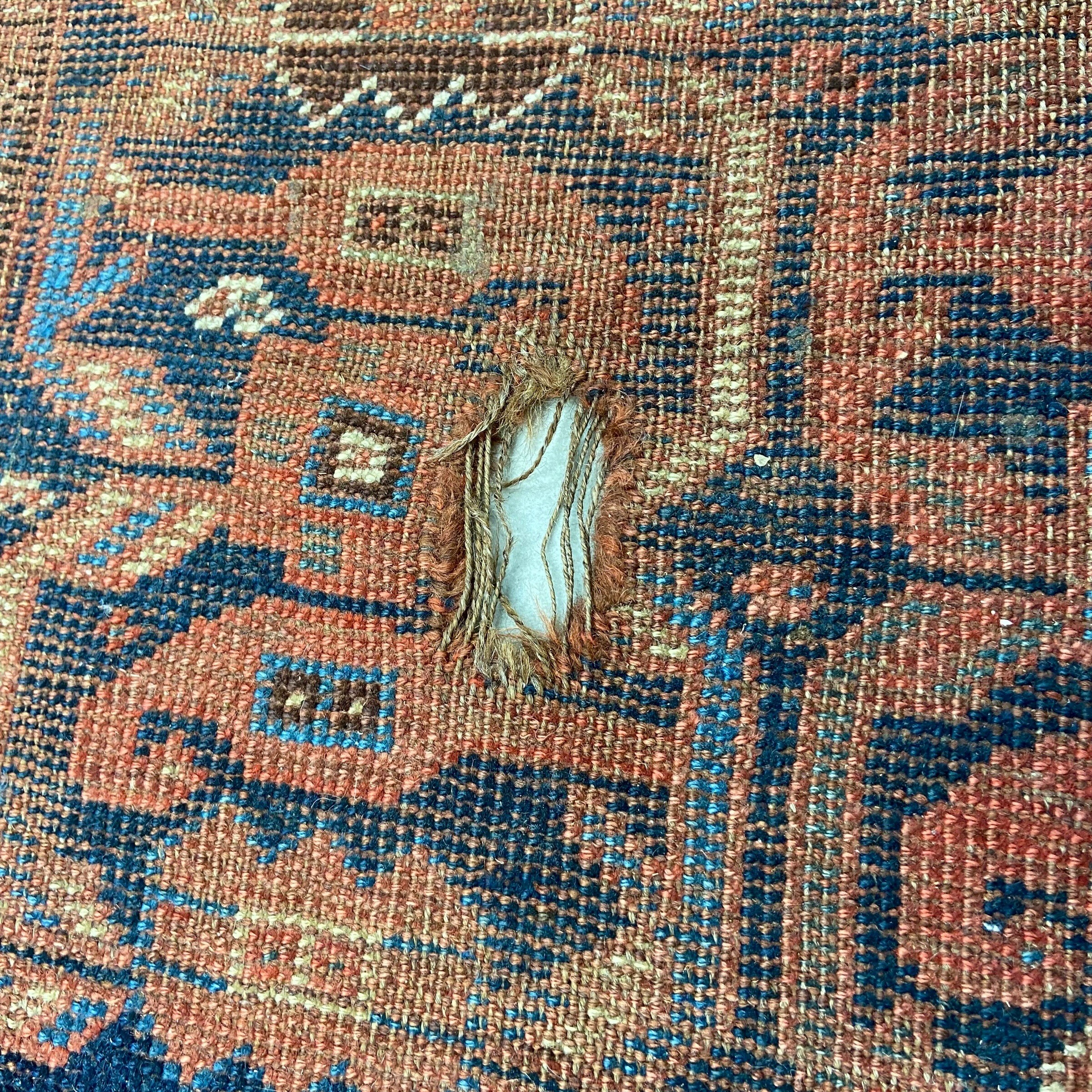 A large Persian Baluch carpet with five rows of sixteen polychrome guls over a midnight blue - Image 4 of 5