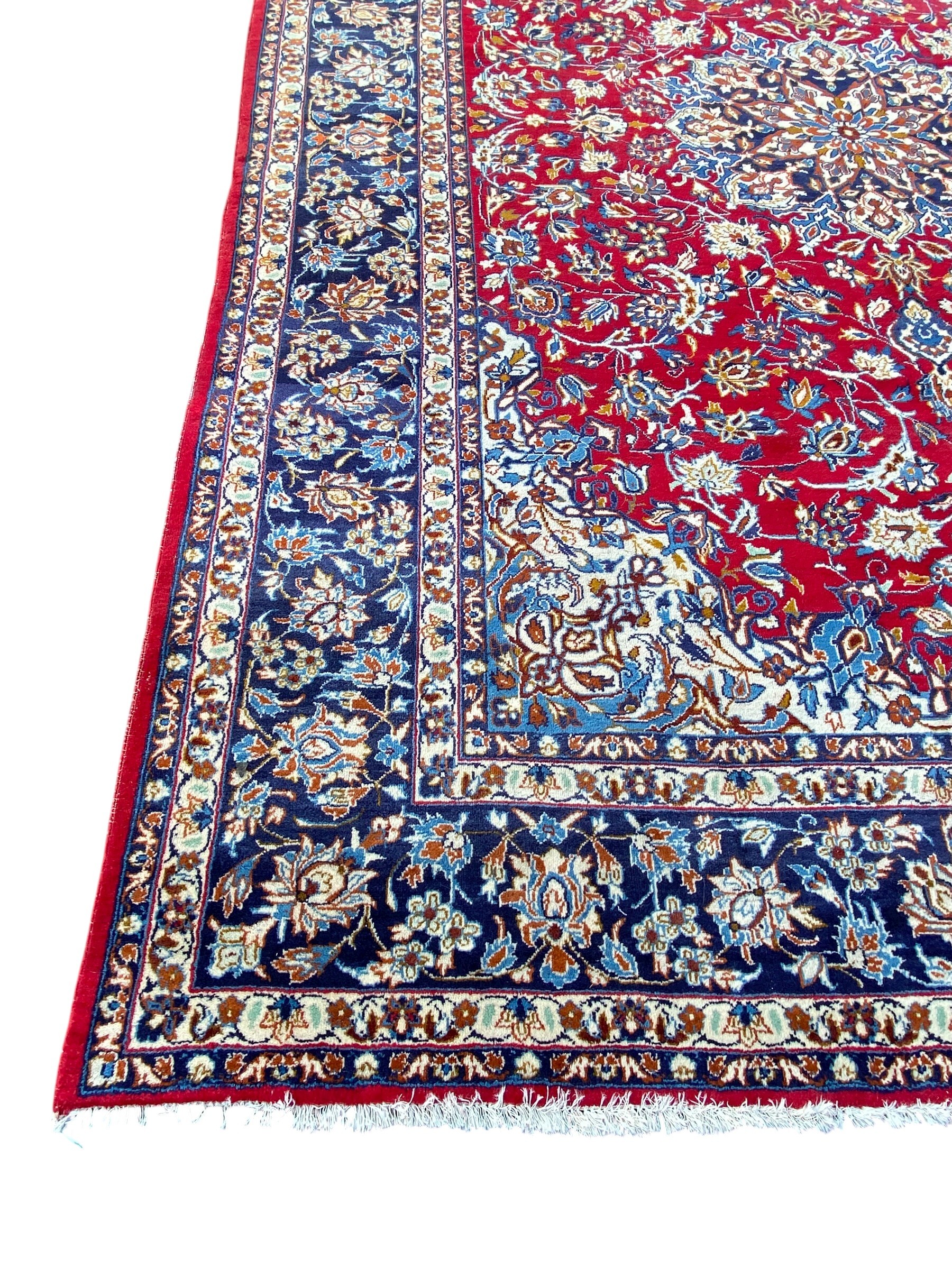 A large Persian Najafabad carpet with central flowerhead medallion in the polychrome field over a - Image 3 of 4