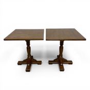 A pair of contemporary square side or occasional tables raised on turned baluster form pedestals