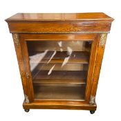 A 19th century walnut pier cabinet with figured top over the marquetry inlaid frieze and glazed door