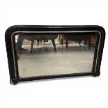 A late 19th century overmantel mirror with shaped plate in a black lacquered and gilt frame.