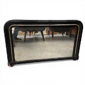 A late 19th century overmantel mirror with shaped plate in a black lacquered and gilt frame.