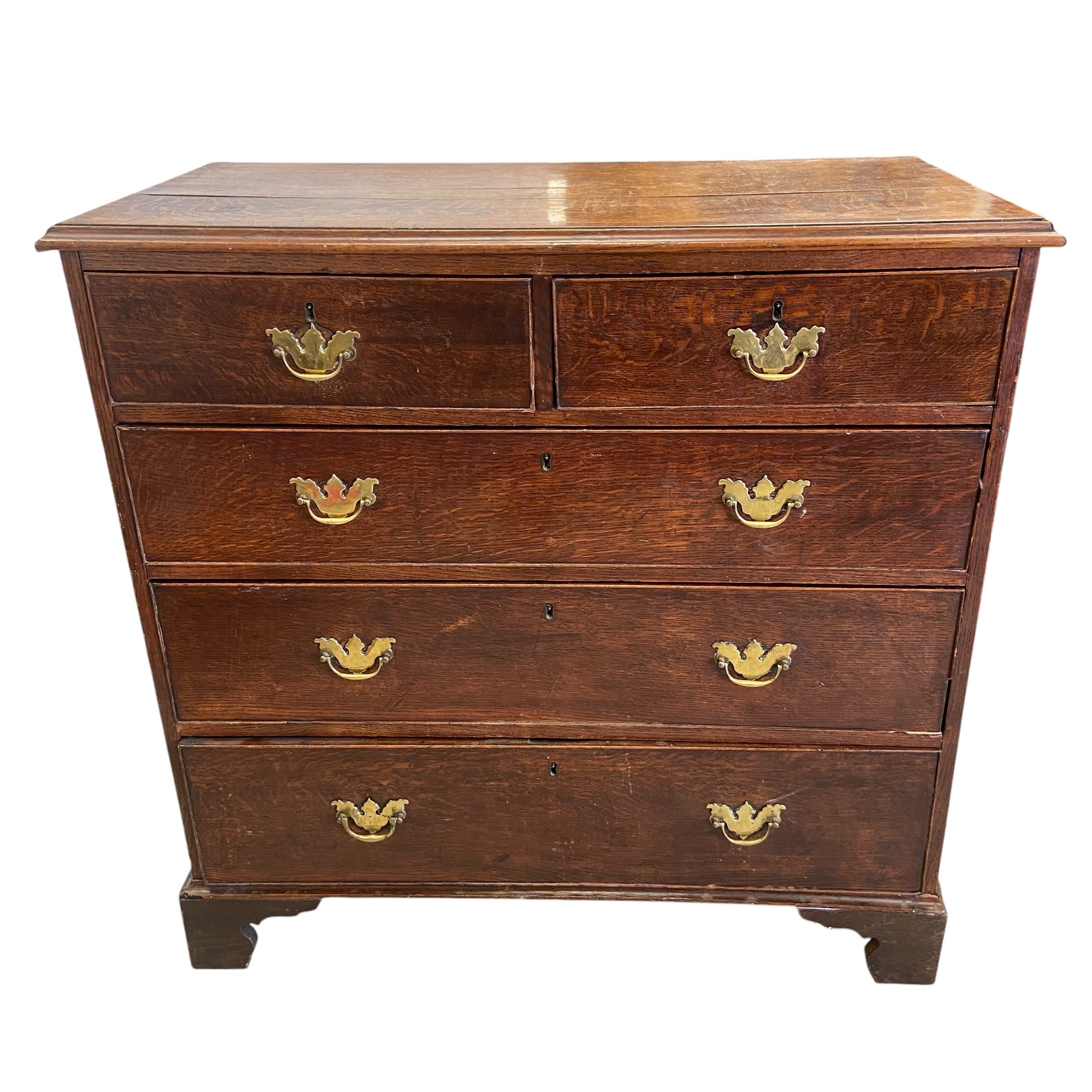 A Georgian oak chest of two short over three long cockbeaded drawers raised on bracket supports. H.