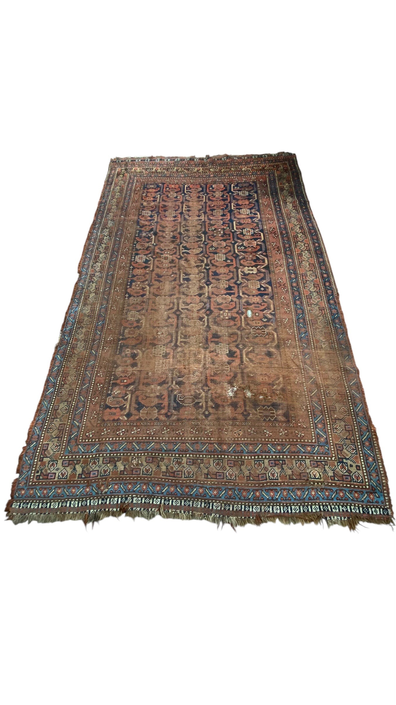 A large Persian Baluch carpet with five rows of sixteen polychrome guls over a midnight blue