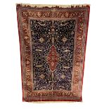A signed Persian silk Qum rug with central lozenge medallion in a scrolling field over the